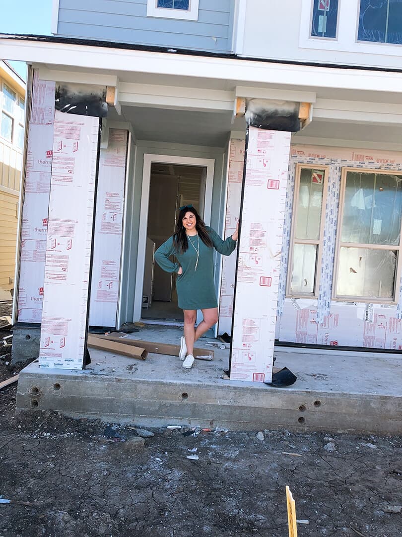 Jenna H in front of her home under construction in Easton Park Austin Texas