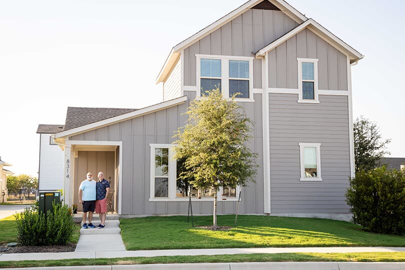 Homeowners stand in front of their home in Easton Park, Austin Texas