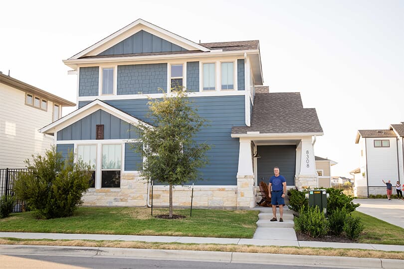A homeowner stands in front of their home in Easton Park in Austin Texas 