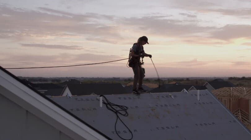 Person standing on a roof at sunset at Easton Park by Brookfield Residential in Austin, TX