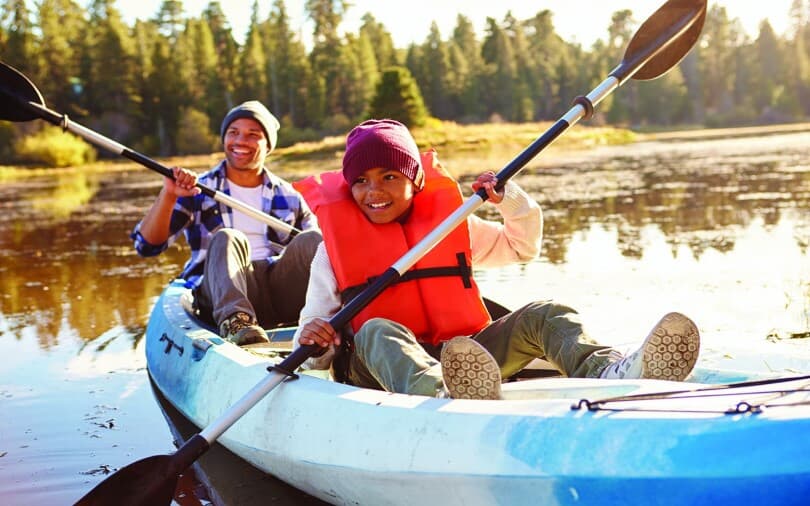 Father and son on a kayak on a lake at the Bluffs at Sleeter Lake in Round Hill, VA