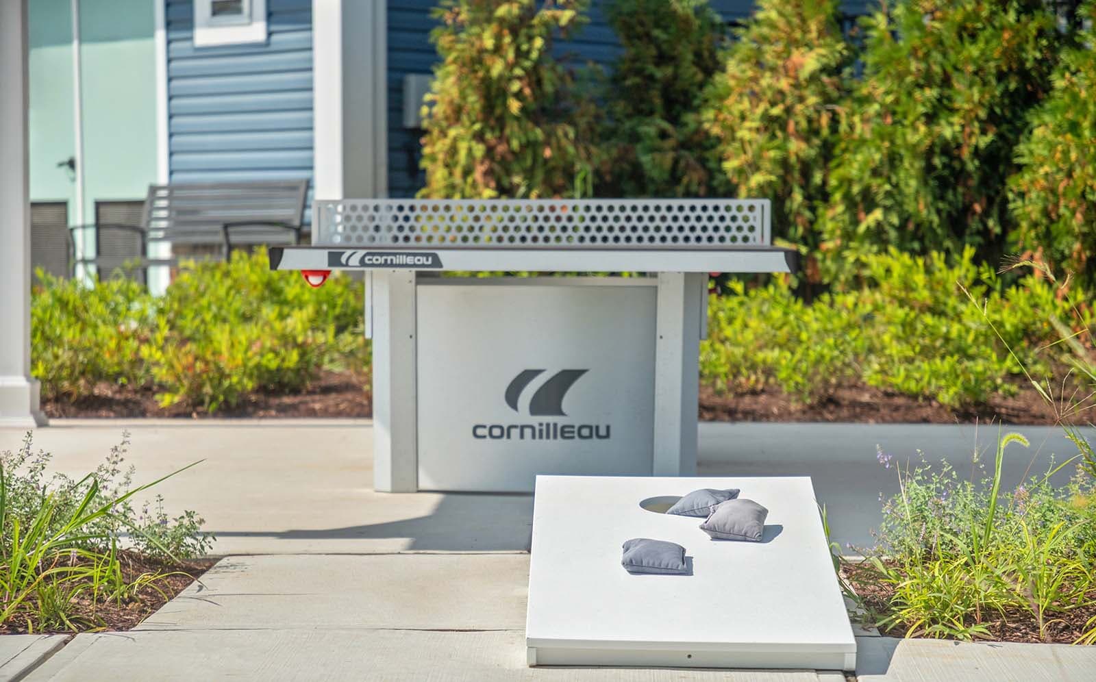 Outdoor play with corn hole and ping pong poolside at Lakeside at Trappe.