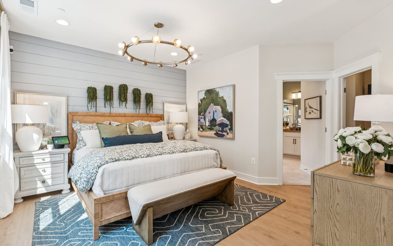 The main level primary bedroom of the Torrington at Lakeside at Trappe.