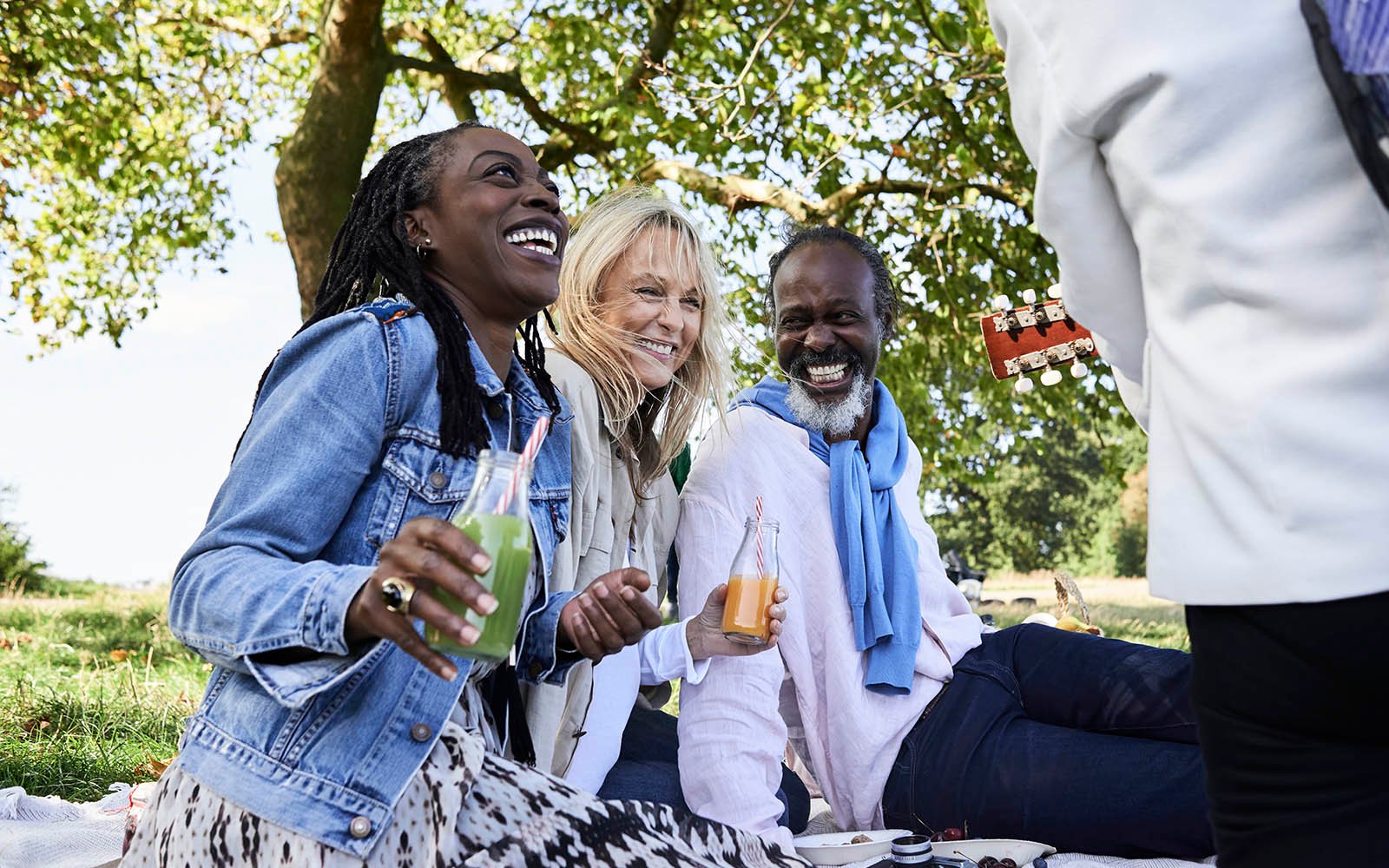 Friends enjoying a lawn picnic.