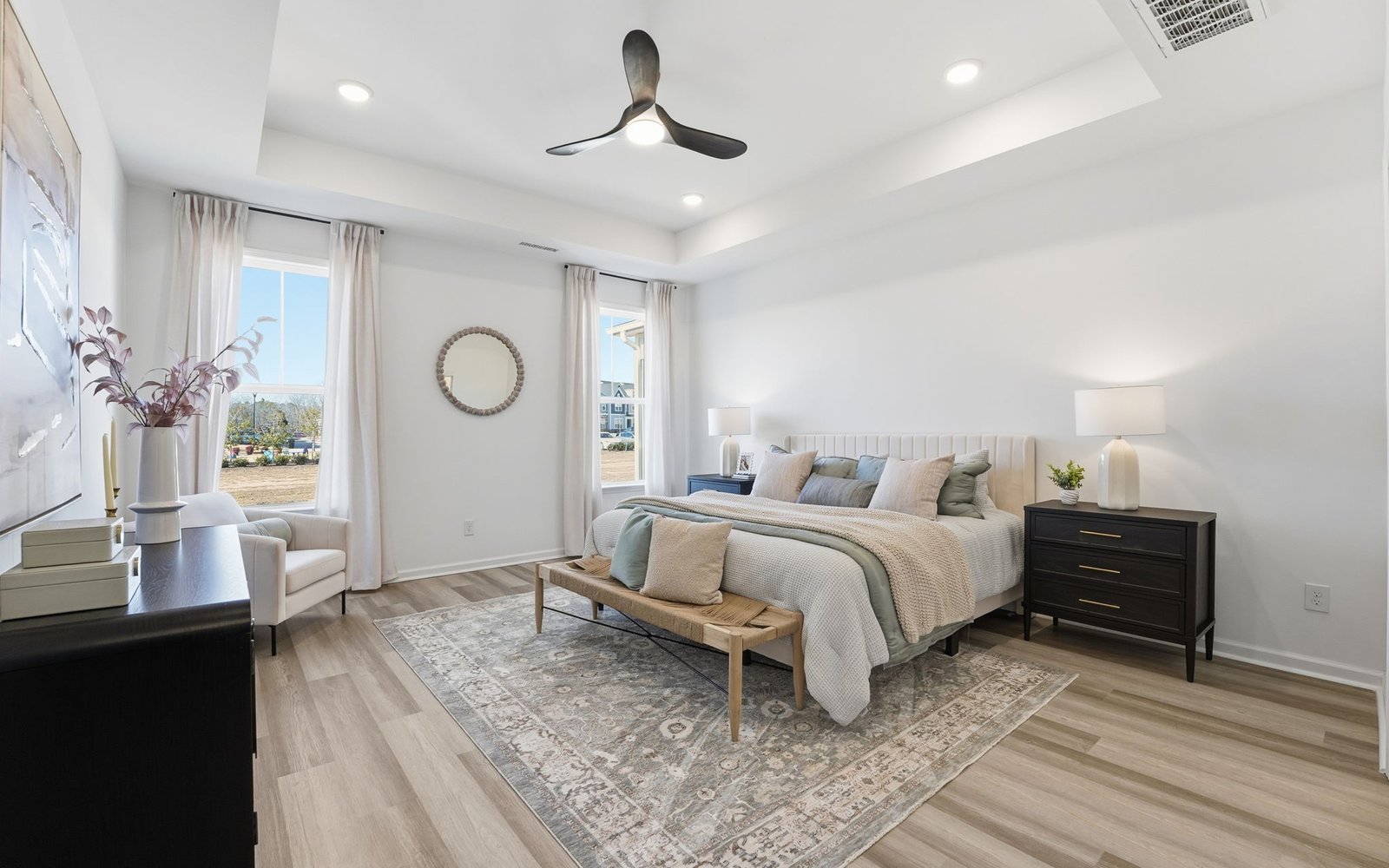 The main level primary bedroom of the Delaney by Brookfield Residential.