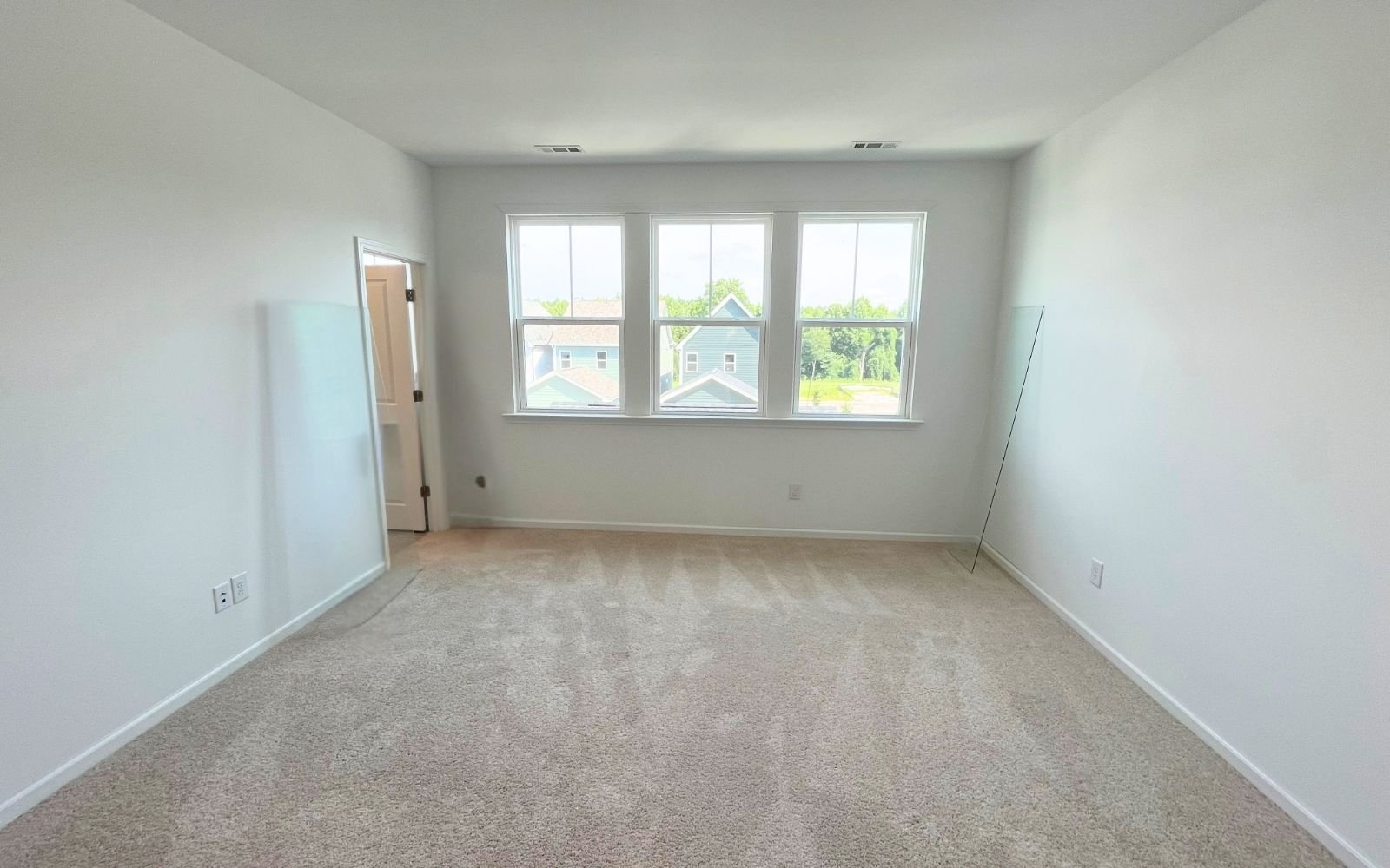 The primary bedroom of the Carter by Brookfield Residential at Wendell Falls.