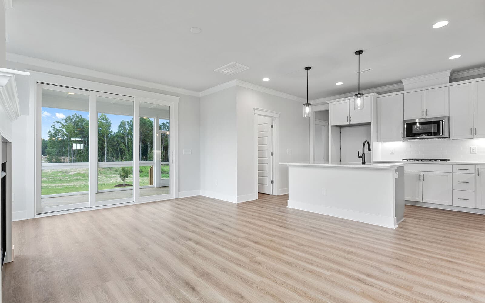 The kitchen and great room of the Mason at Wendell Falls by Brookfield Residential
