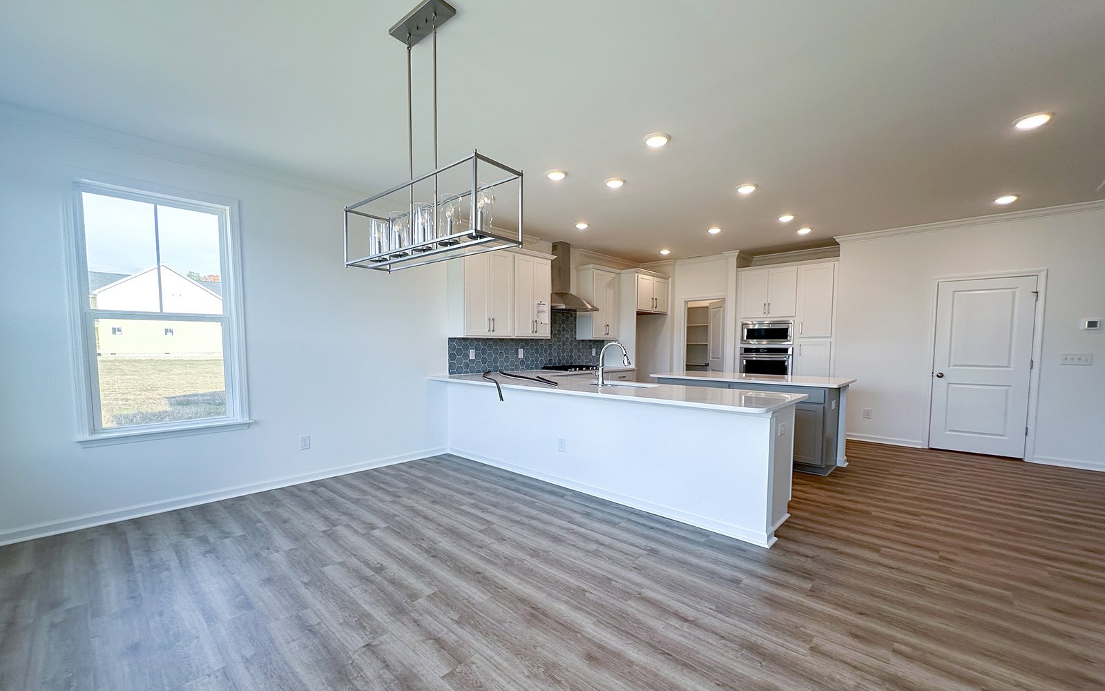 The dining room and kitchen of the Sterling on homesite 2435 at Wendell Falls.