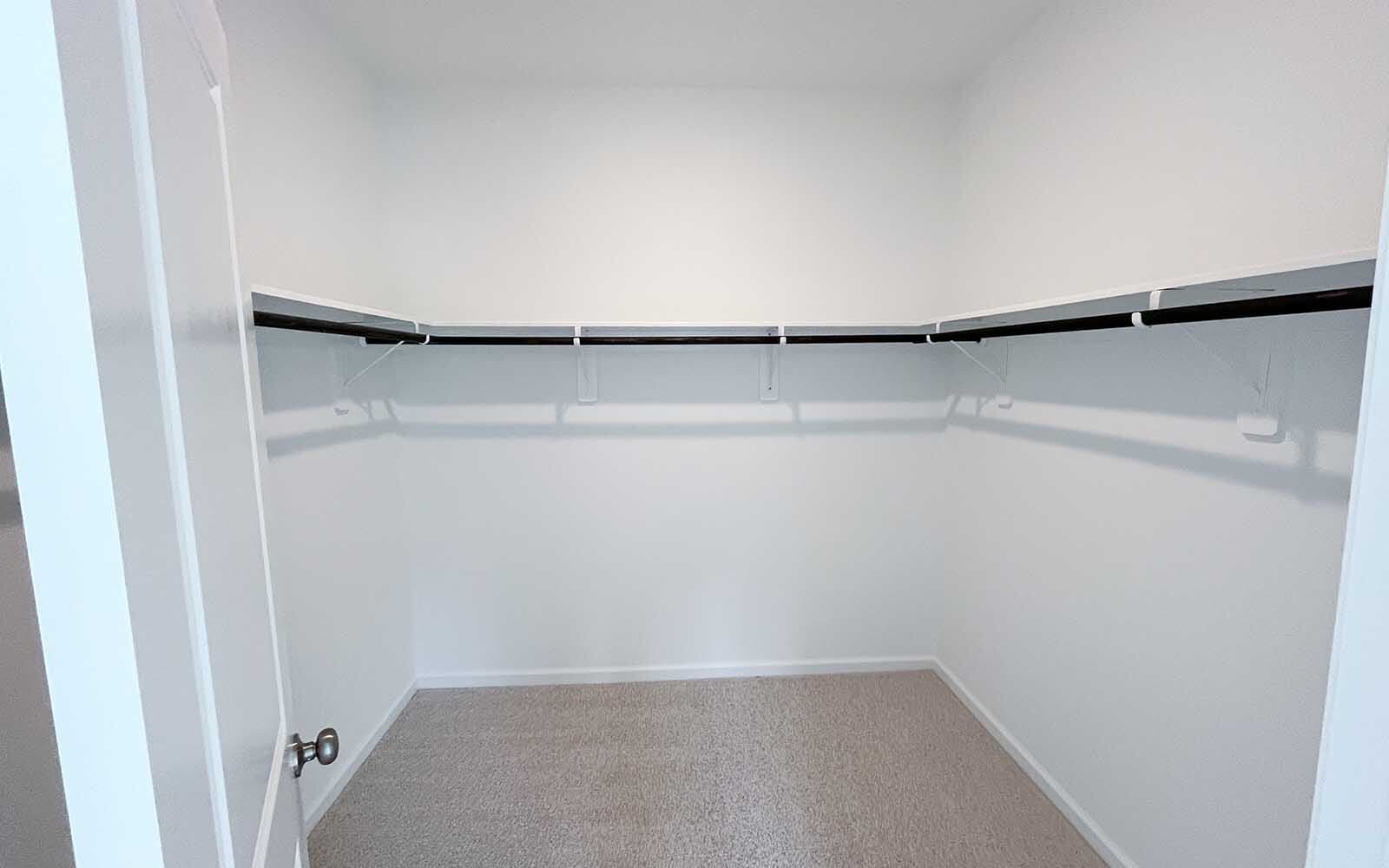 The primary bedroom walk-in closet in the Sterling by Brookfield Residential on homesite 2643. 