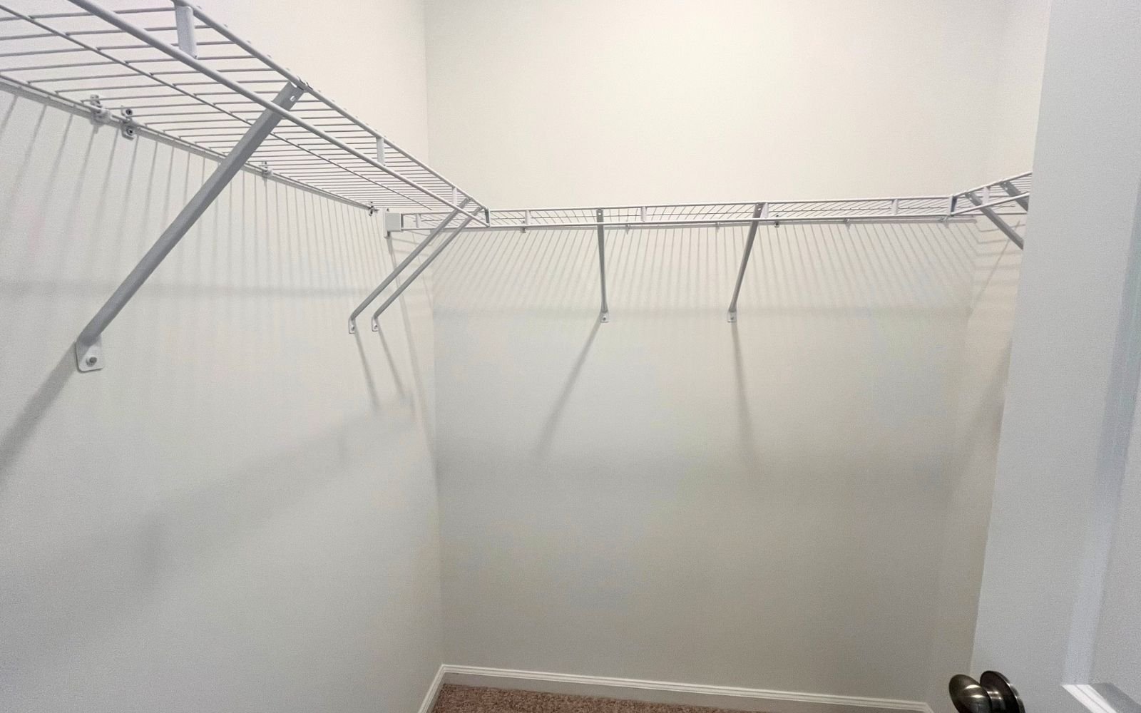 A walk-in closet in the Lennox on homesite 2579 by Brookfield Residential at Wendell Falls.