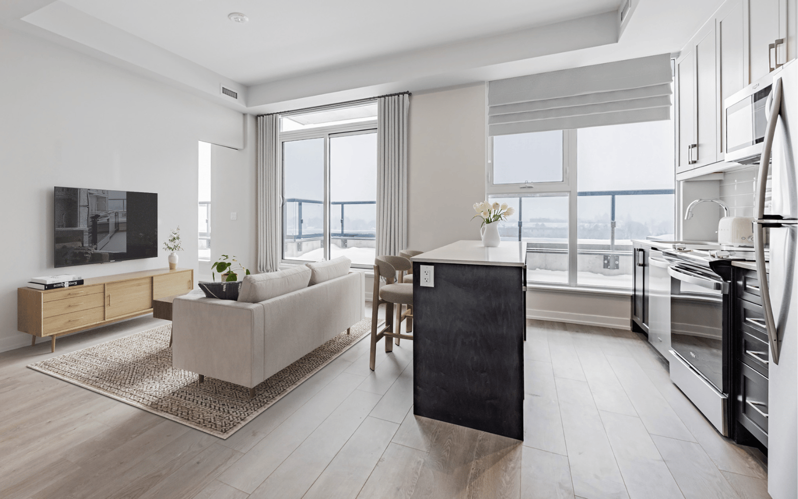 Virtually staged photo of the kitchen and living area in a Hopkins plan at Station No. 3 in Whitby, ON