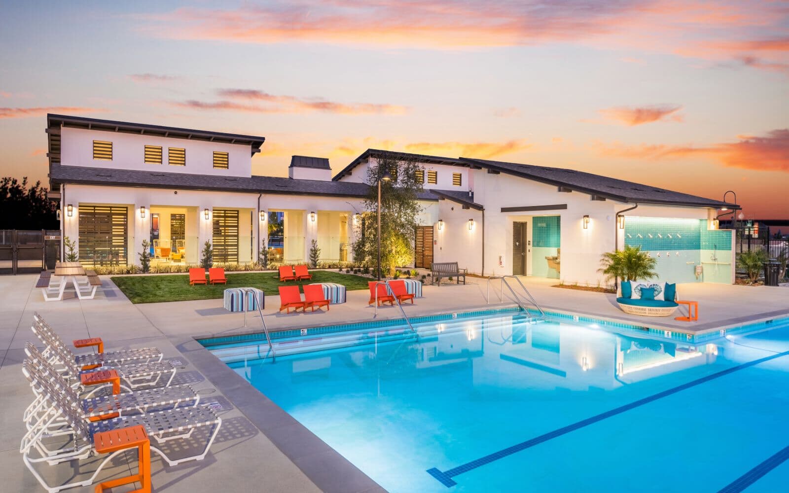 View of Canvas Park pool and clubhouse at sunset within the community of New Haven