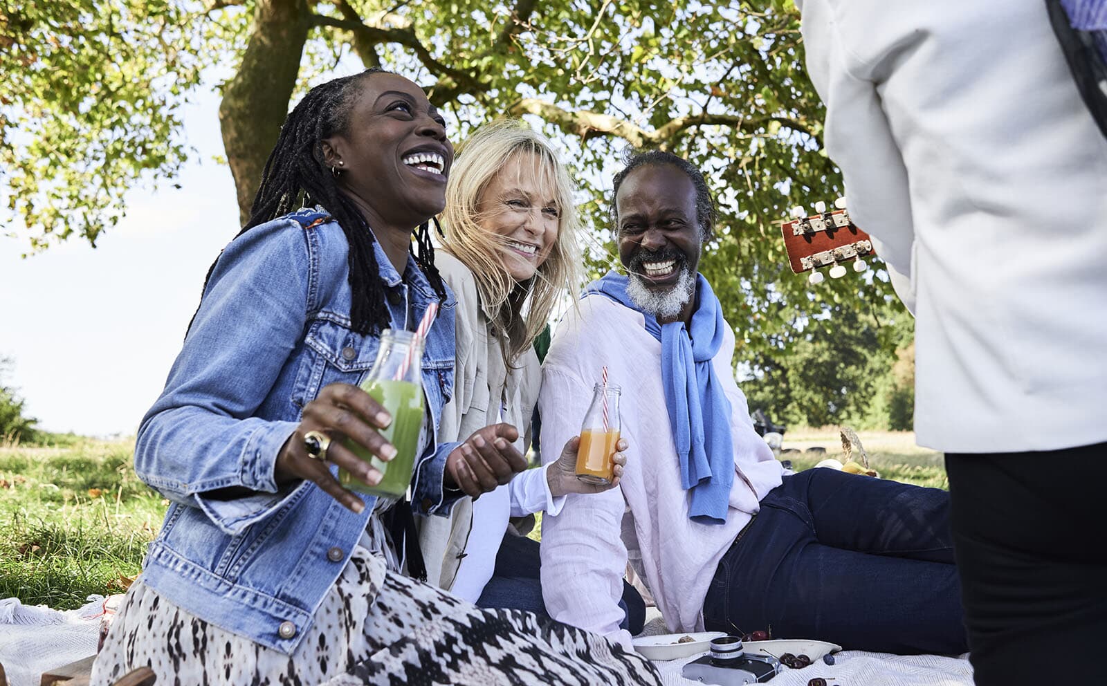 Friends enjoying music outside on a lawn