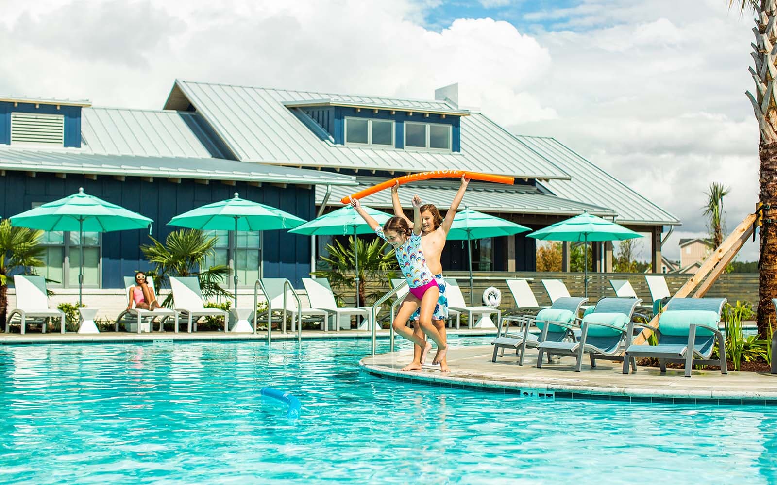 Kids jumping into the pool at Midtown Club at Nexton