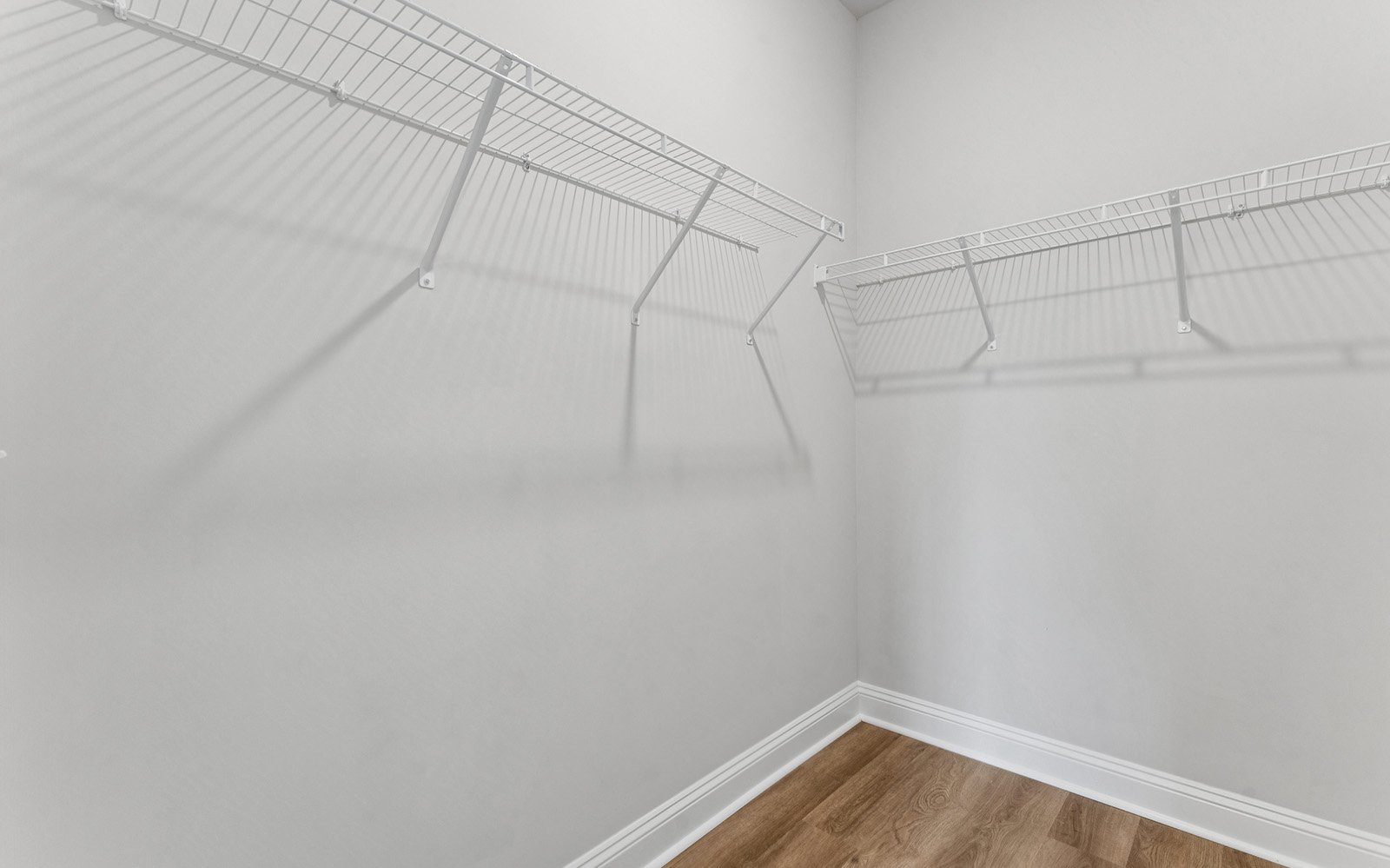 The primary bedroom walk-in closet in the Preston single family home by Brookfield Residential at Nexton.