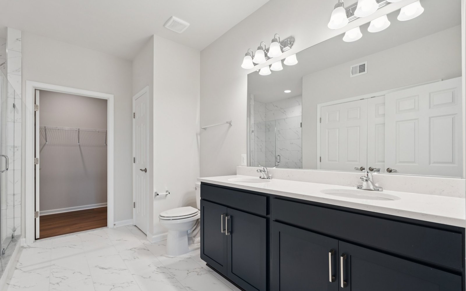 The main level primary bathroom in a Fitzgerald garden home at Hiatt Pointe at Snowden Bridge.