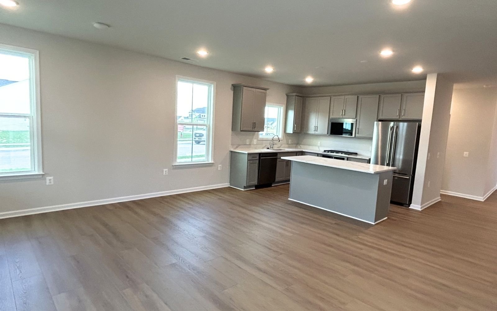 The family room and kitchen of the Fitzgerald on homesite 2001 at Hiatt Pointe at Snowden Bridge.