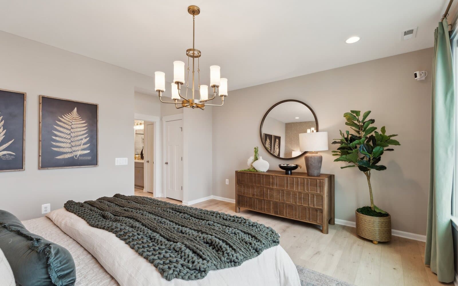 The main level primary bedroom of the Hemingway by Brookfield Residential.