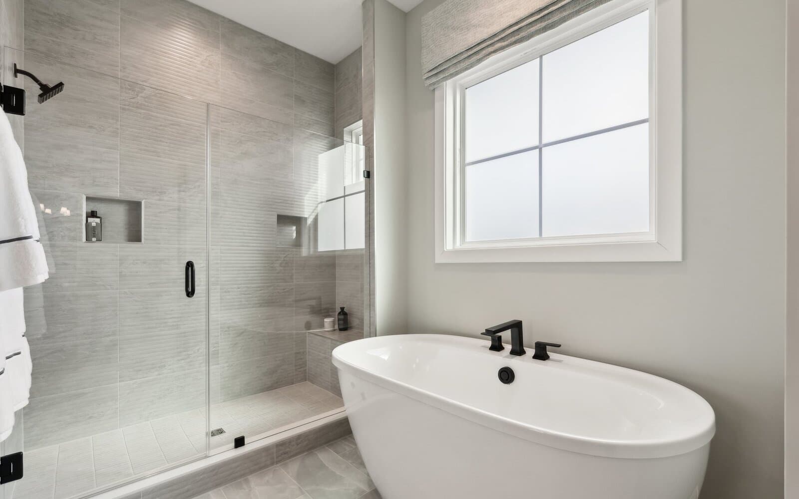 The deluxe primary bathroom in the Matisse model single family home at Hiatt Pointe at Snowden Bridge by Brookfield Residential.