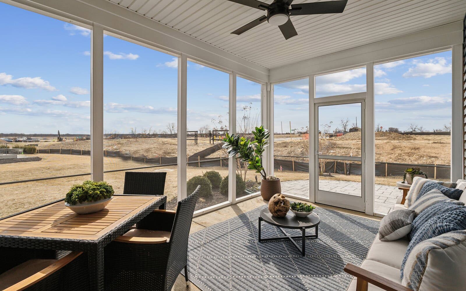 The screened porch of the Northgate by Brookfield Residential at dusk.