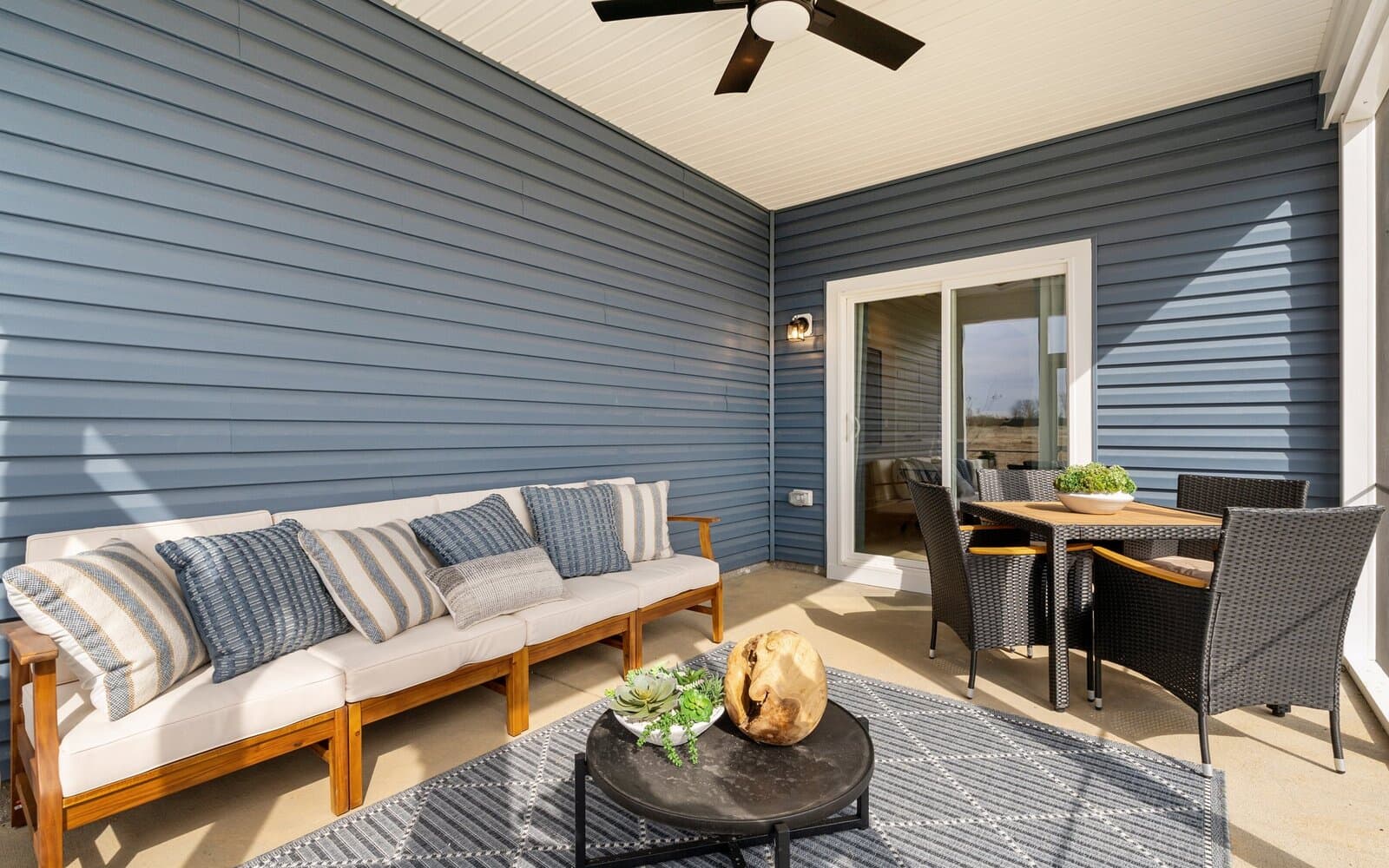 The screened porch of the Northgate by Brookfield Residential at dusk.