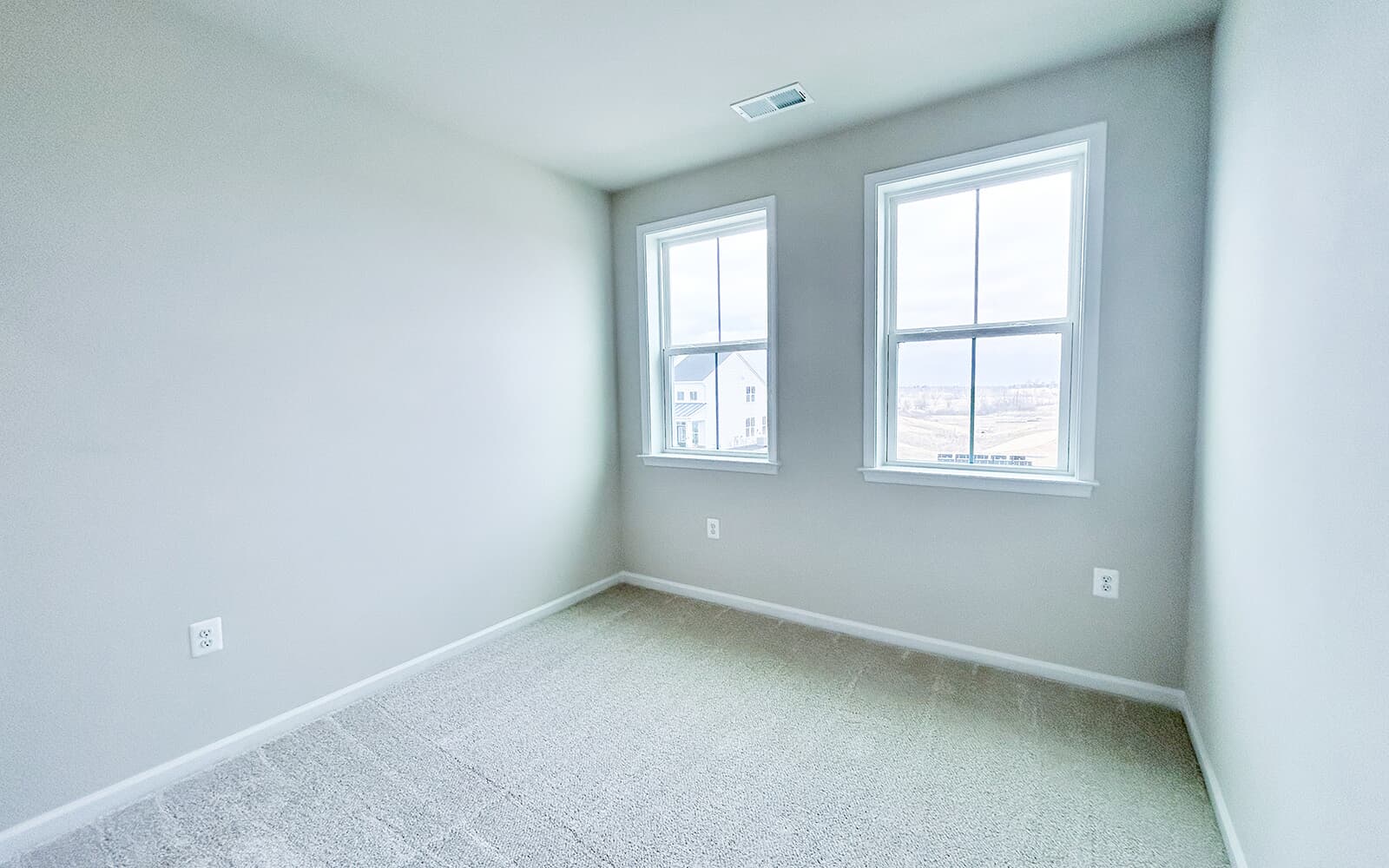 A secondary bedroom in the Northgate villa home on homesite 1028 at Hiatt Pointe at Snowden Bridge by Brookfield Residential.