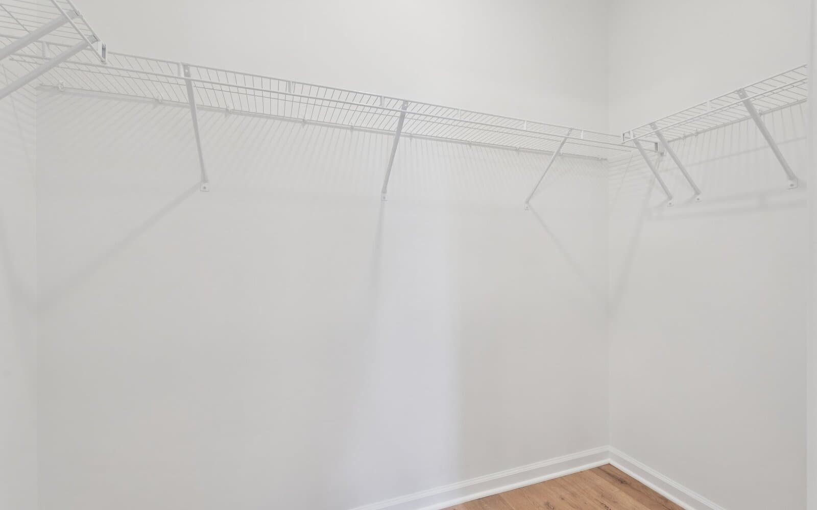 The main level primary suite walk-in closet of the Northgate by Brookfield Residential on homesite 1002 at Hiatt Pointe at Snowden Bridge.