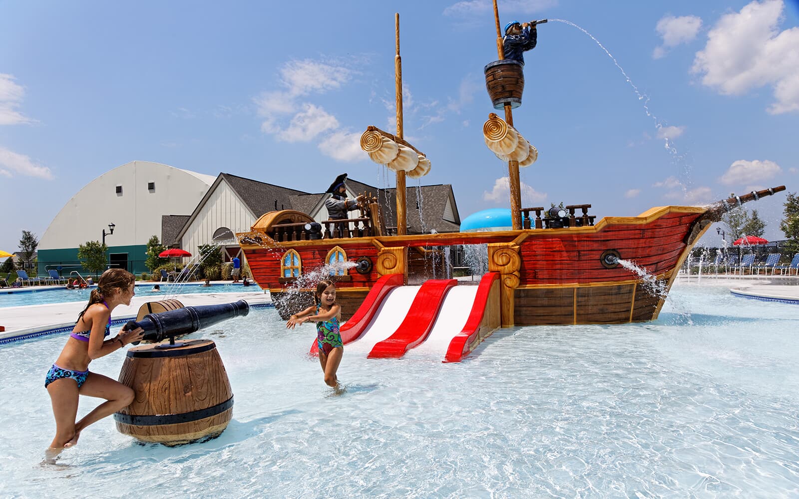 A pool with a pirate water splash area and swimming lanes 
