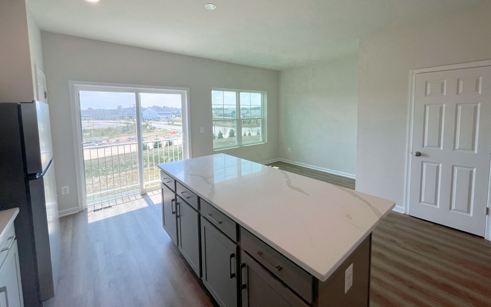 The kitchen and dining area of the Skyline on homesite 24016 at Snowden Bridge.