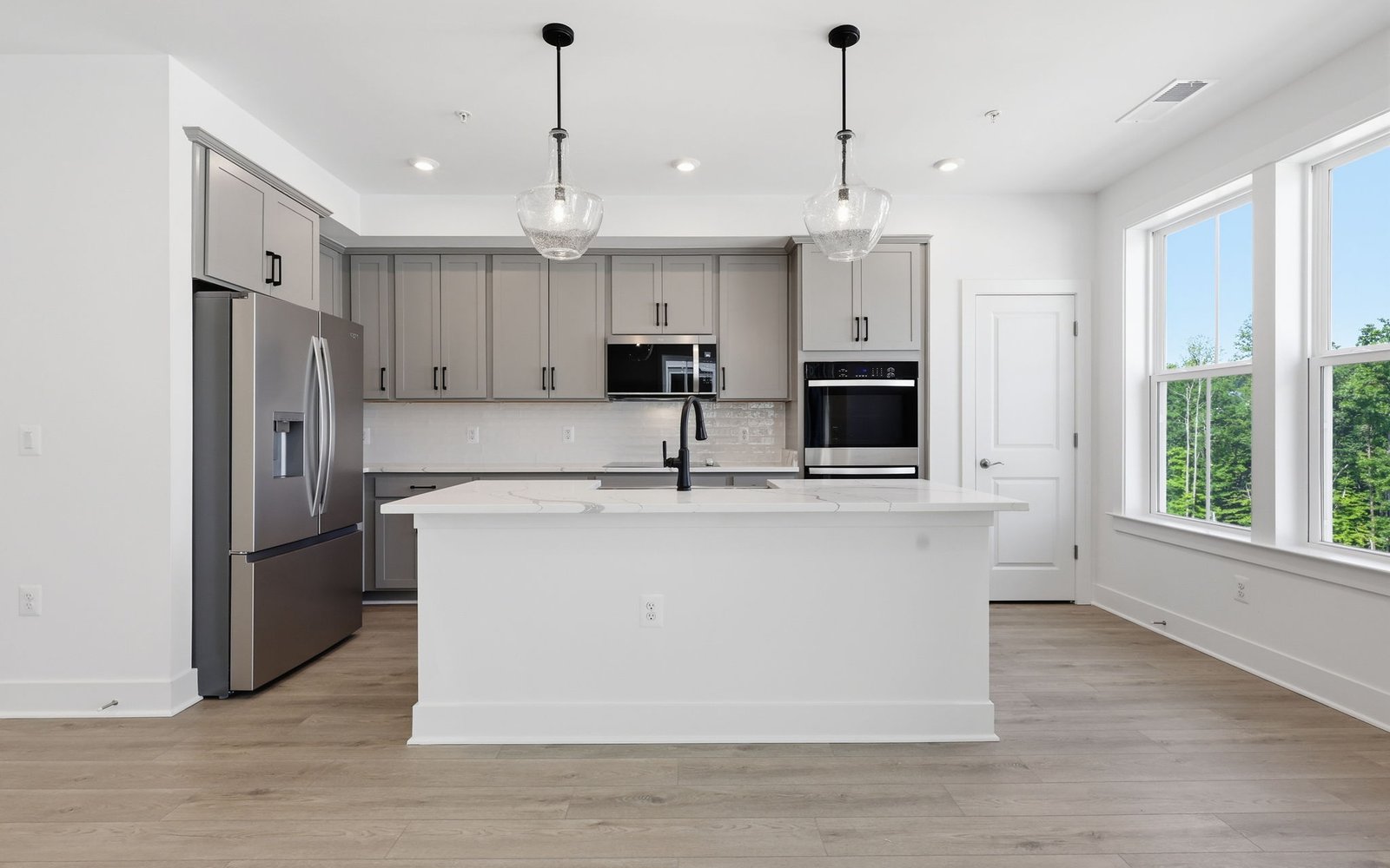 The kitchen layout showcasing the upgraded package 2 finishes in the Scarlet at Cascades at Embrey Mill.