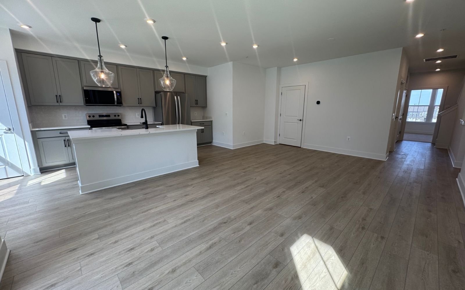 The family room and kitchen of the Amber on homesite 139 at Cascades at Embrey Mil.