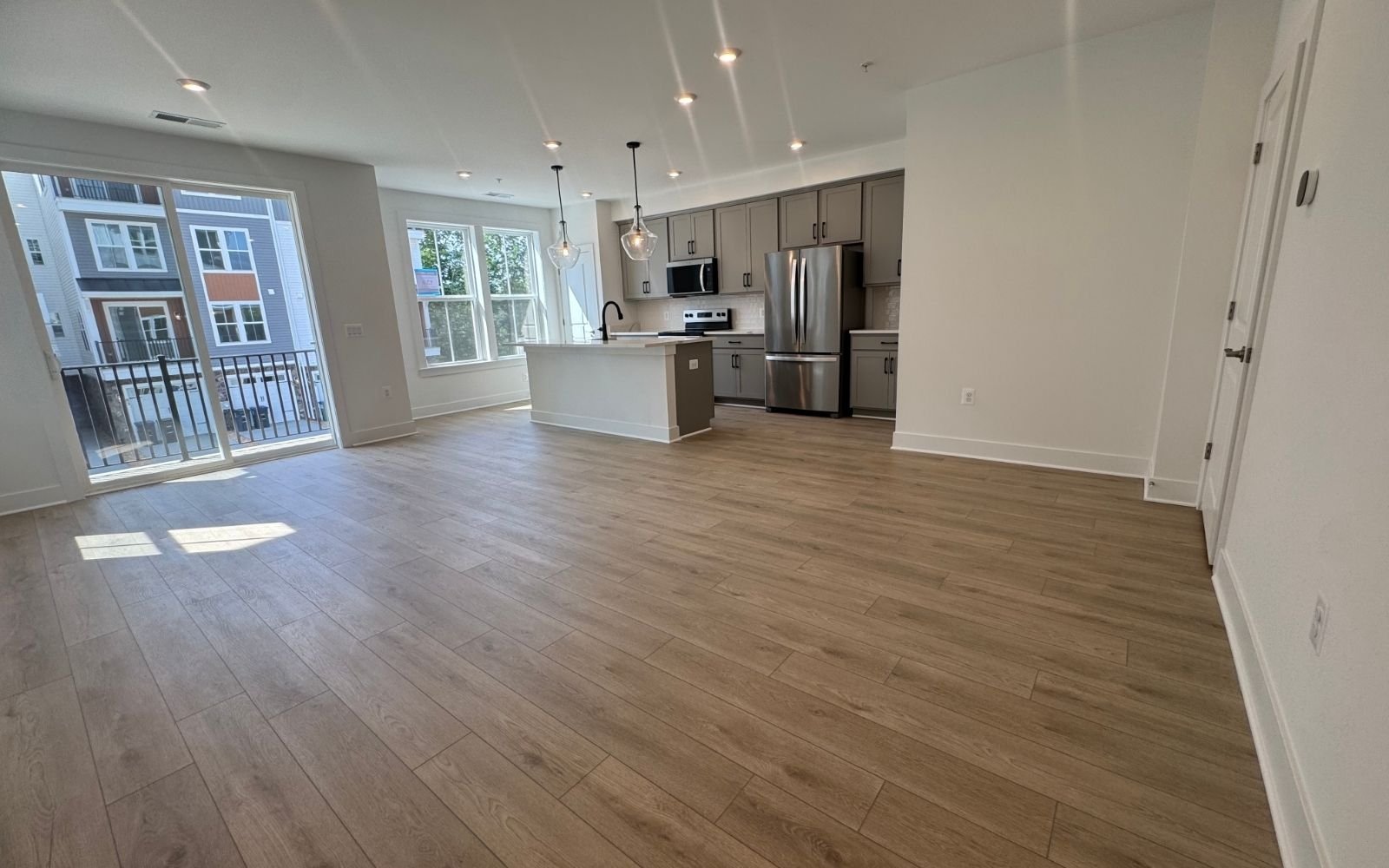 The family room and kitchen of the Amber on homesite 139 at Cascades at Embrey Mil.