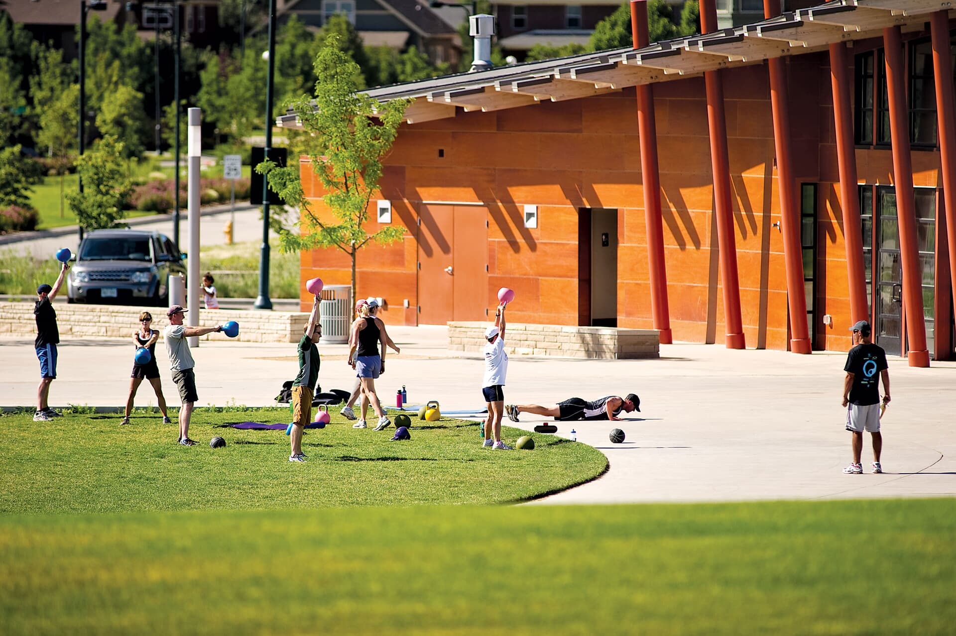 Lifestyle photo of residents working out outside at Central Park community in Denver, CO.
