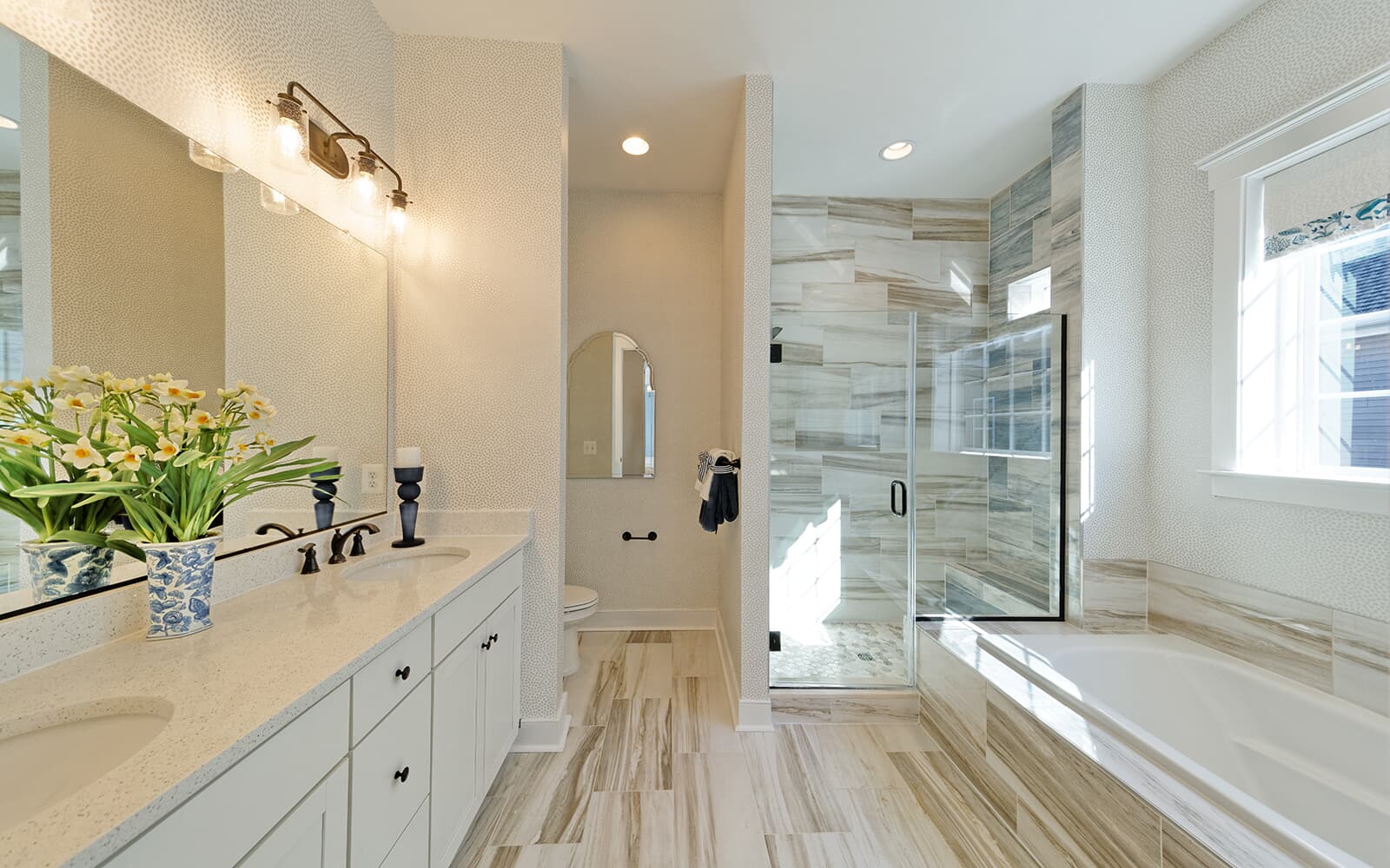 The deluxe bathroom of the primary bathroom in the Monet by Brookfield Residential