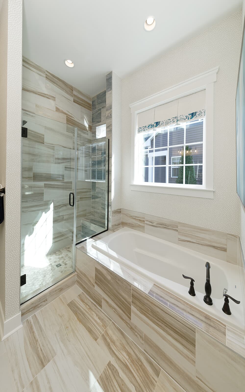 The deluxe bath of the primary bathroom in the Monet by Brookfield Residential