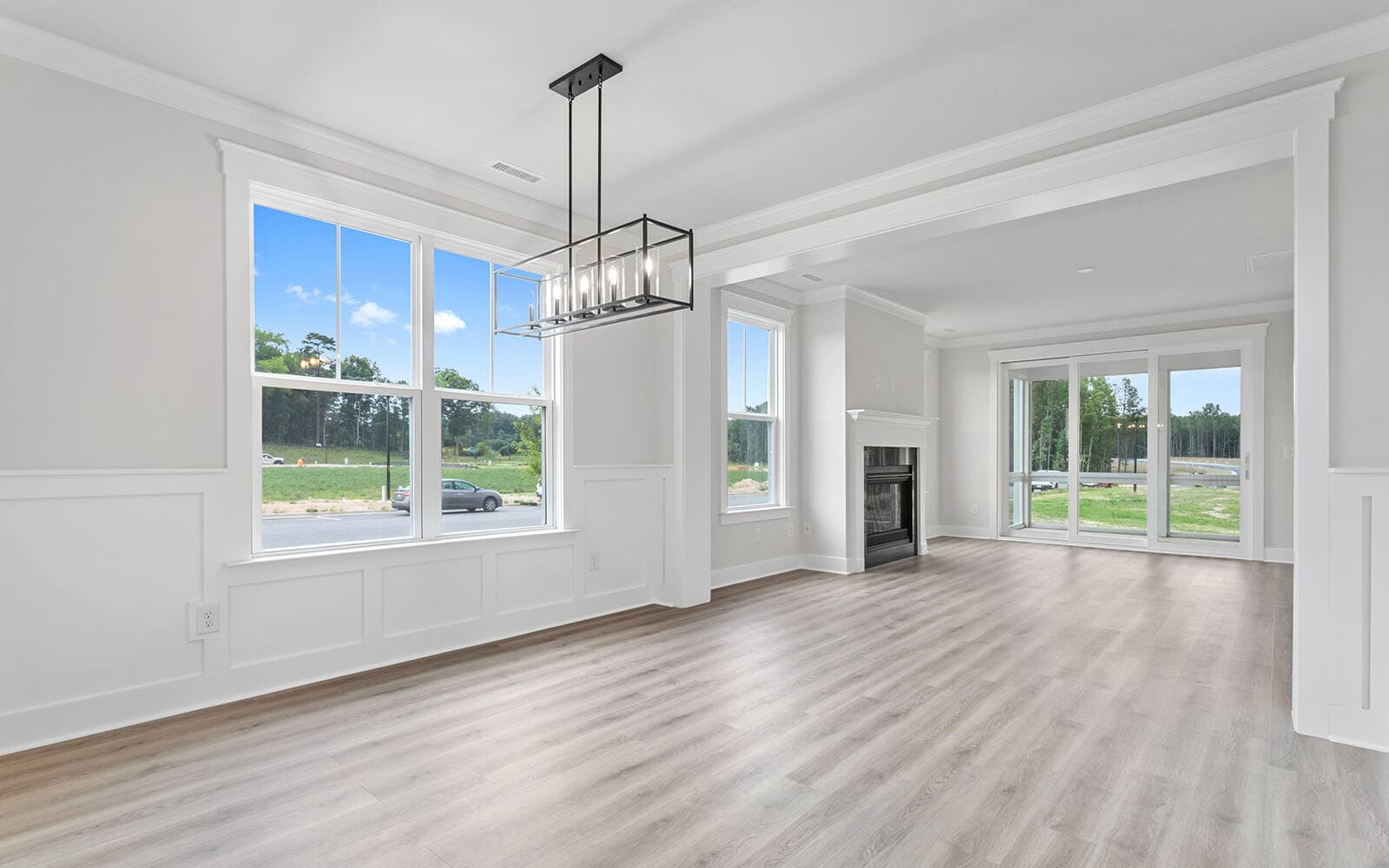 The main level great room and dining room of the Mason at Wendell Falls by Brookfield Residential