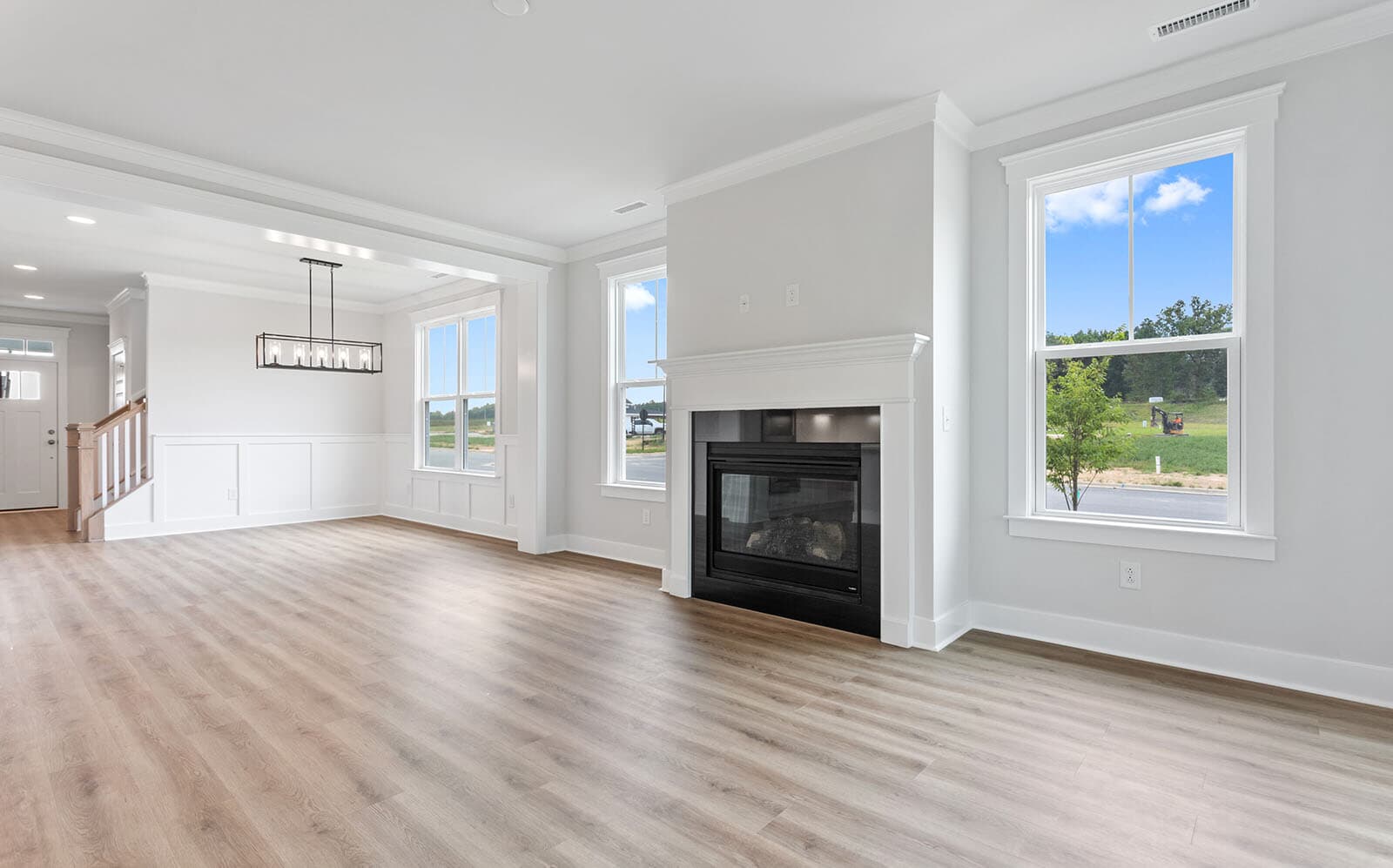 The main level great room and dining room of the Mason at Wendell Falls by Brookfield Residential