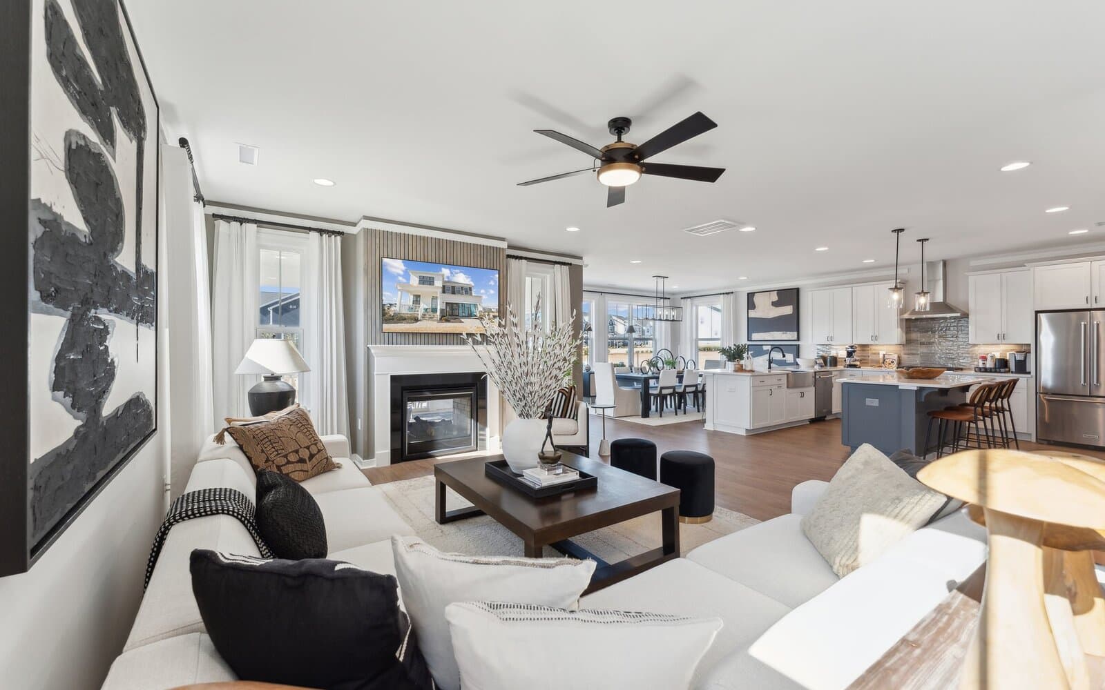 The great room open to the kitchen and dining room of the Sterling by Brookfield Residential.