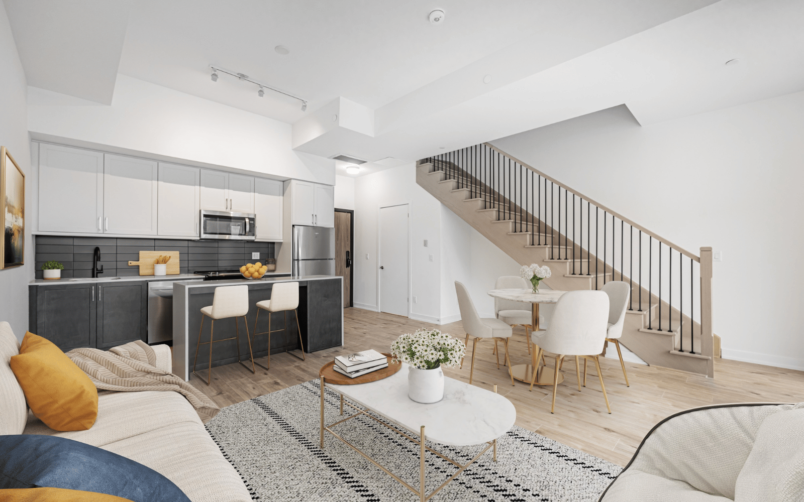 Virtually staged photo of the kitchen and living area in Suite 101 at Station No. 3 in Whitby, ON