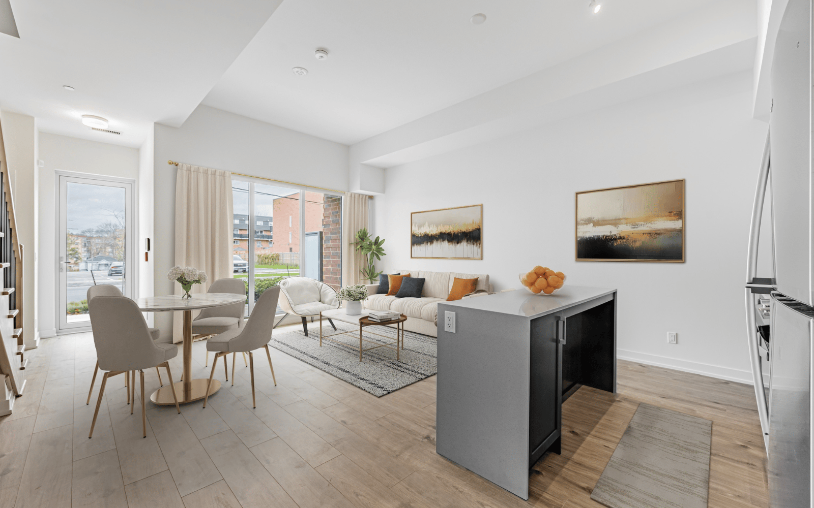 Virtually staged photo of the dining and living area in Suite 101 at Station No. 3 in Whitby, ON