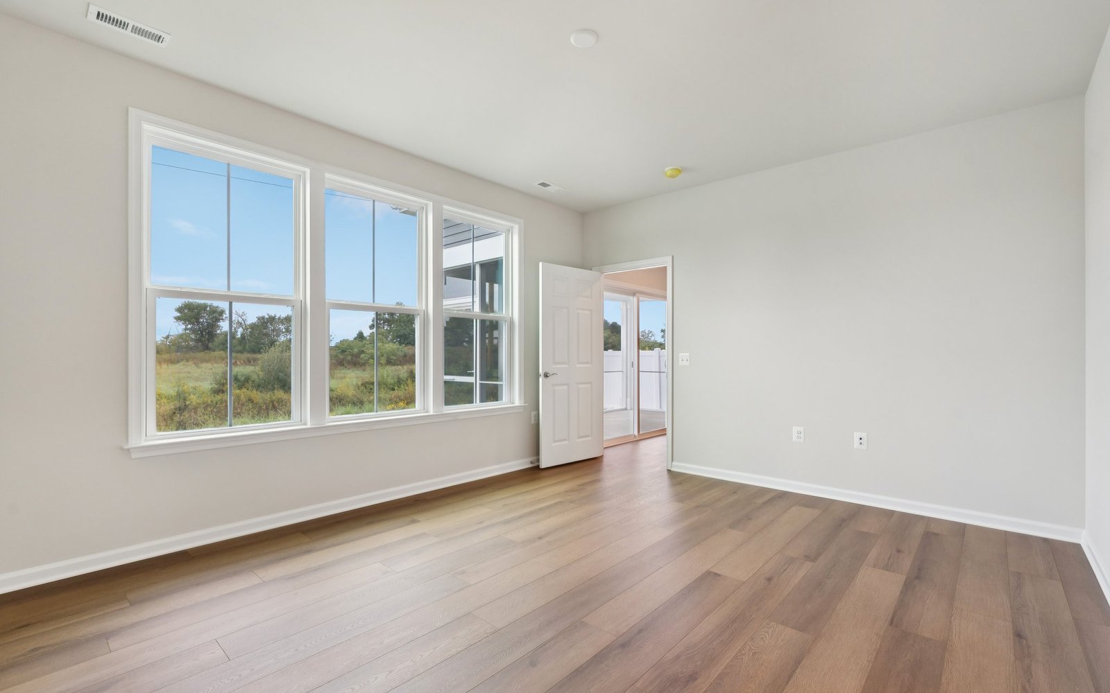 The main level primary bedroom in a Fitzgerald garden home at Hiatt Pointe at Snowden Bridge.