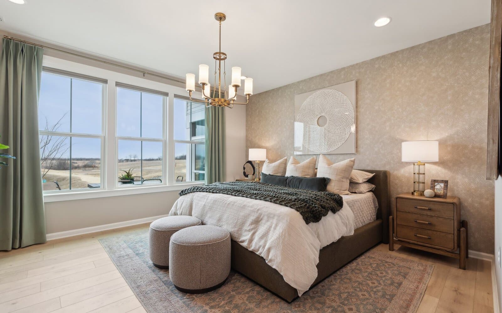 The main level primary bedroom of the Hemingway by Brookfield Residential.