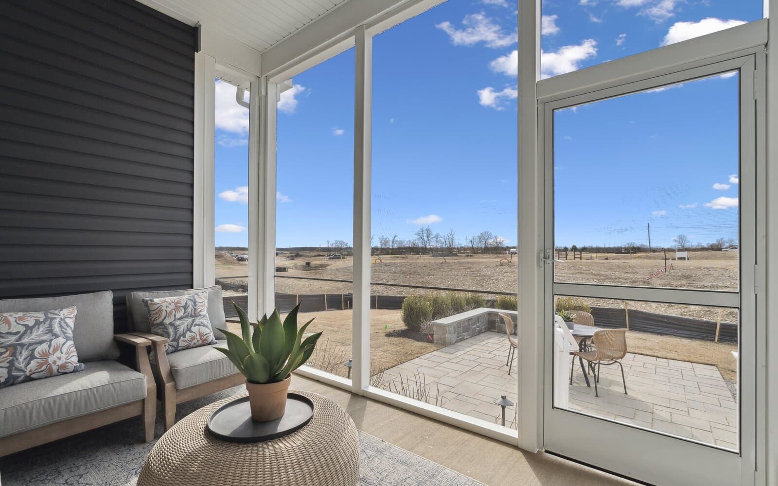 The rear screened porch of the Matisse model single family home at Hiatt Pointe at Snowden Bridge by Brookfield Residential.