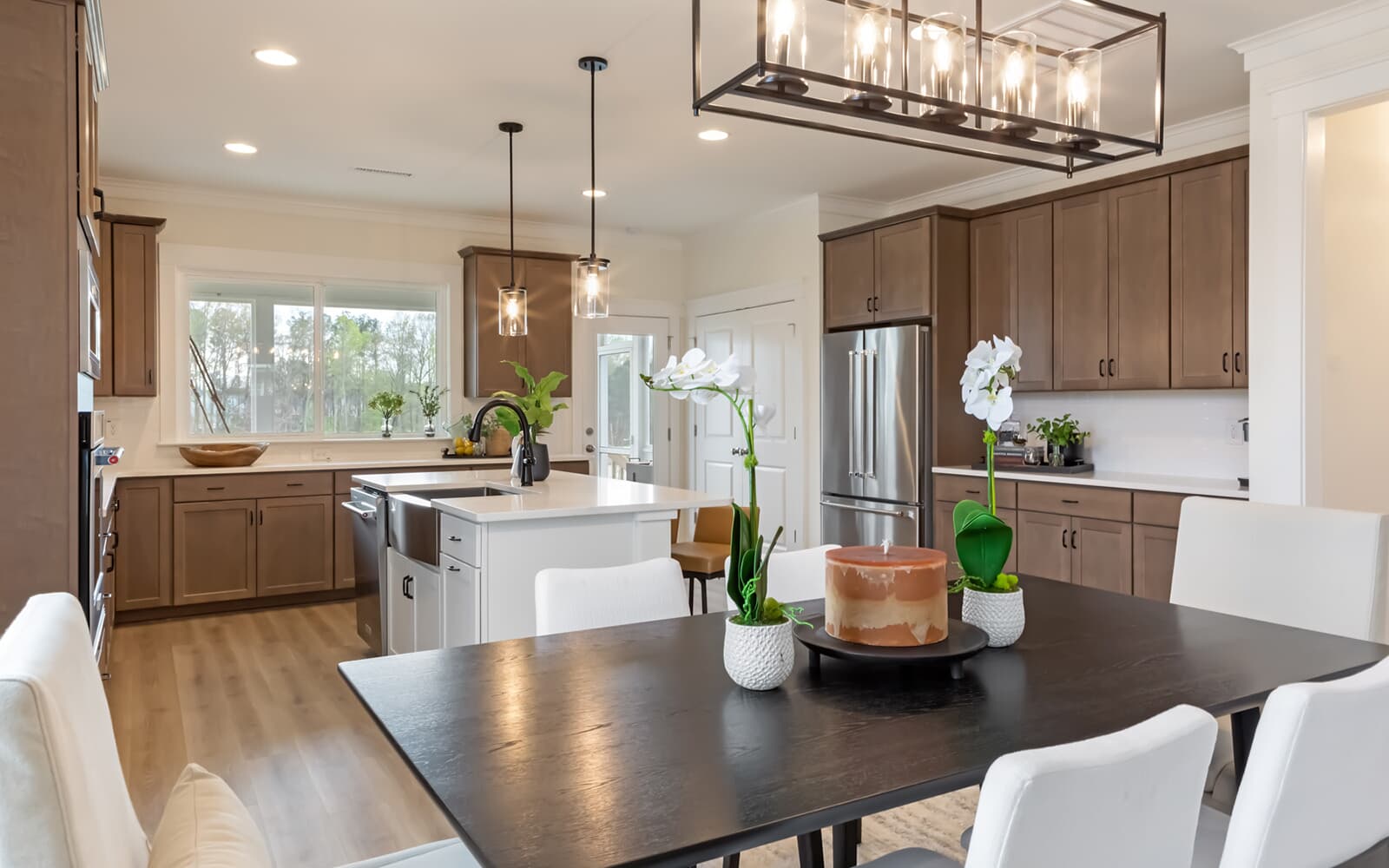 The dining room and kitchen of the Denison by Brookfield Residential