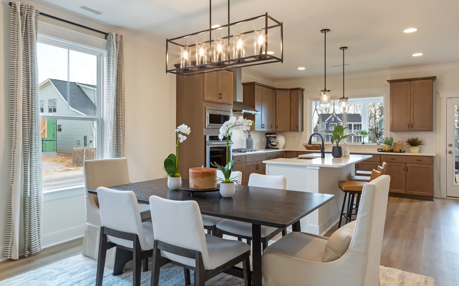 The dining room and kitchen of the Denison by Brookfield Residential