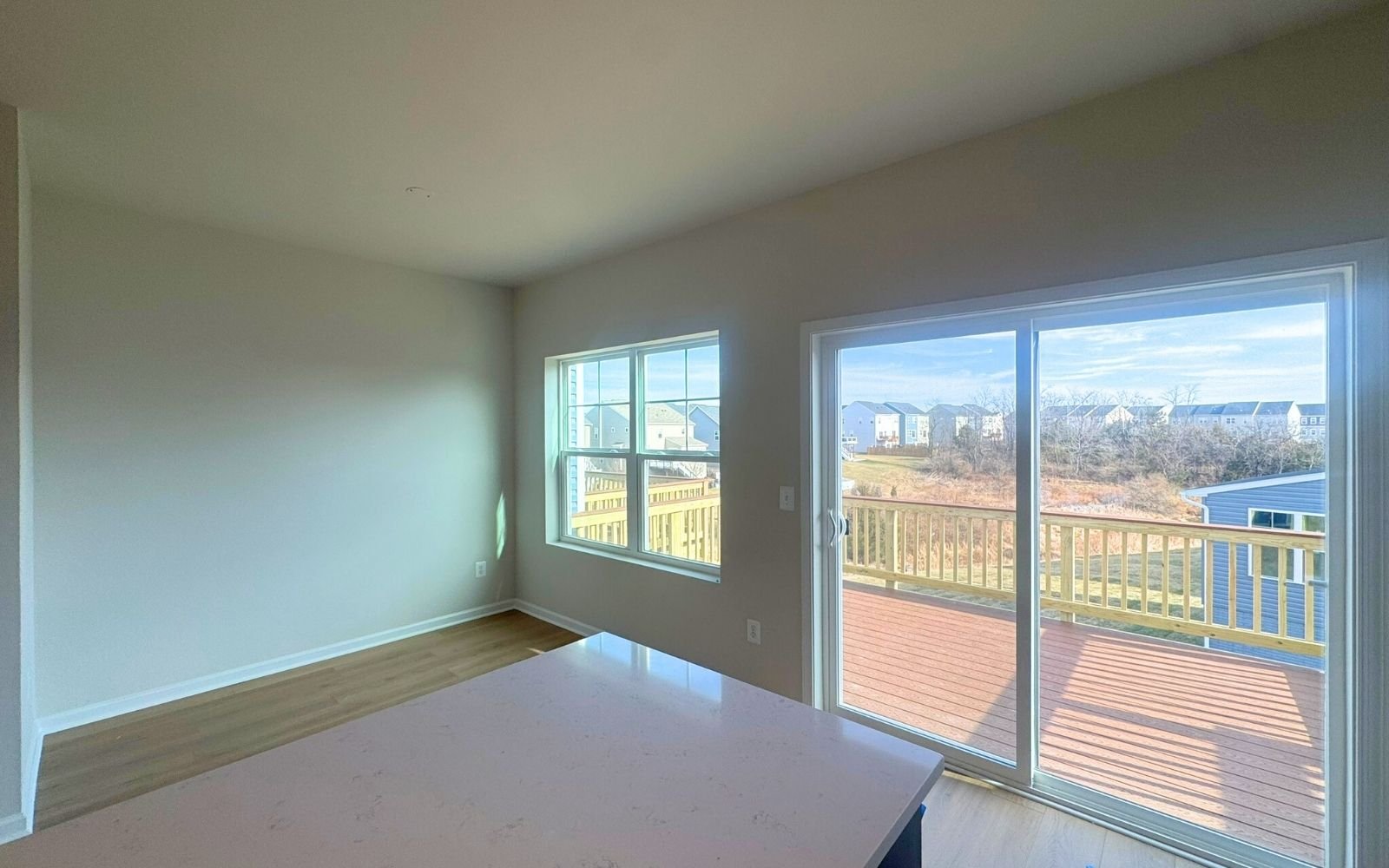 The dining area and sundeck of the Skyline on homesite 2153 at Snowden Bridge.