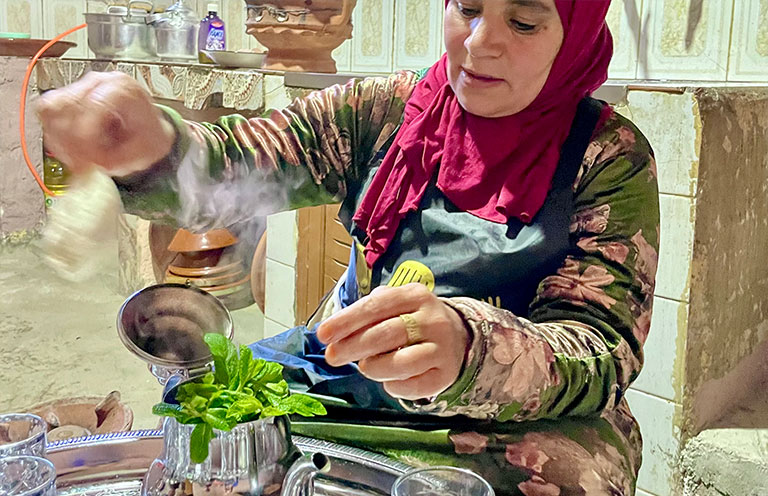 Berber woman brewing mint tea
