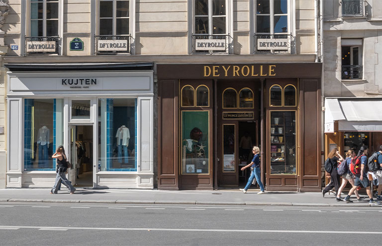 People walking past the historic Deyrolle store on Rue du Bac