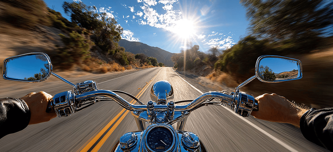 Open Road Motorcycle Adventure: A first-person perspective captures the thrill of a motorcycle ride, the open road stretches ahead under a radiant sky; By Ball