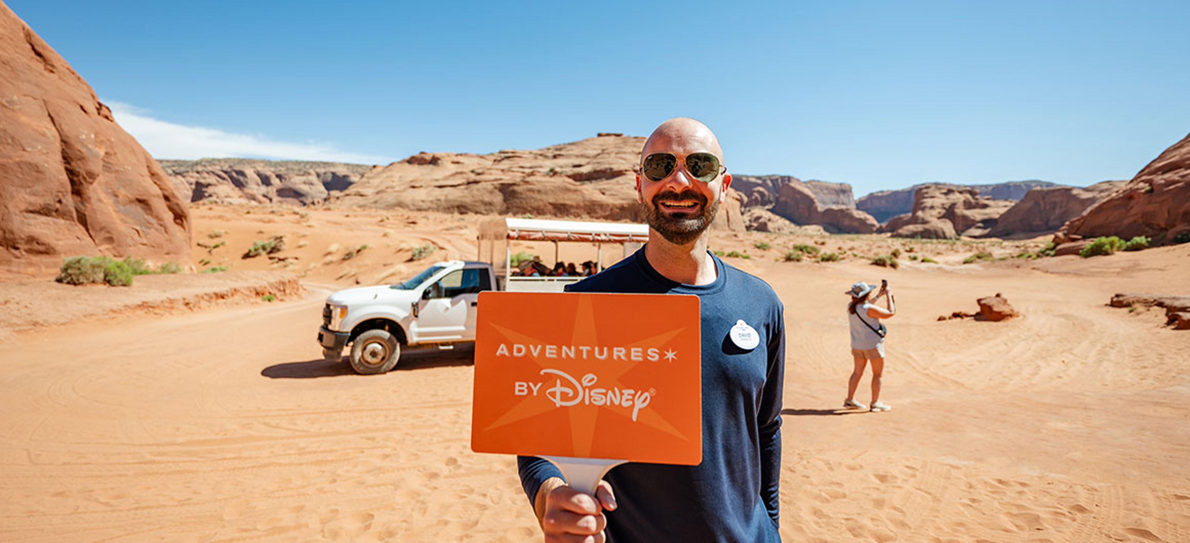 Adventures by Disney guide standing in a desert landscape in Arizona and Utah